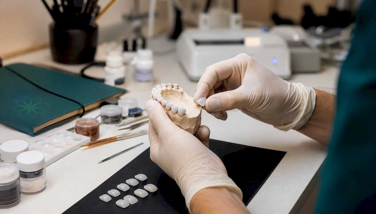 Technician crafting porcelain veneers in lab